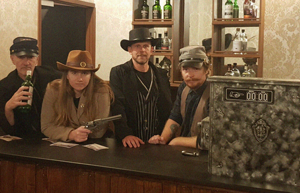 Fox in a Box Gold Coast Wild West Saloon escape room with vintage bar décor, cowboy hats, and rustic Western theme.