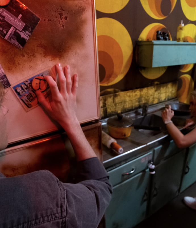 Blindfolded players working together to escape from the Zodiac Killer’s apartment in a thrilling escape room challenge.