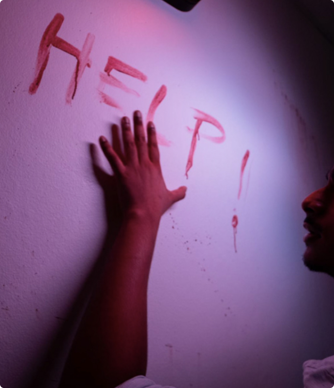 Player reaching out for help inside the Zombie Lab escape room during a high-stress moment.