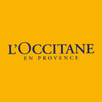 Lote de productos de L'Occitane en Provence en caja amarilla, lujo y belleza.
