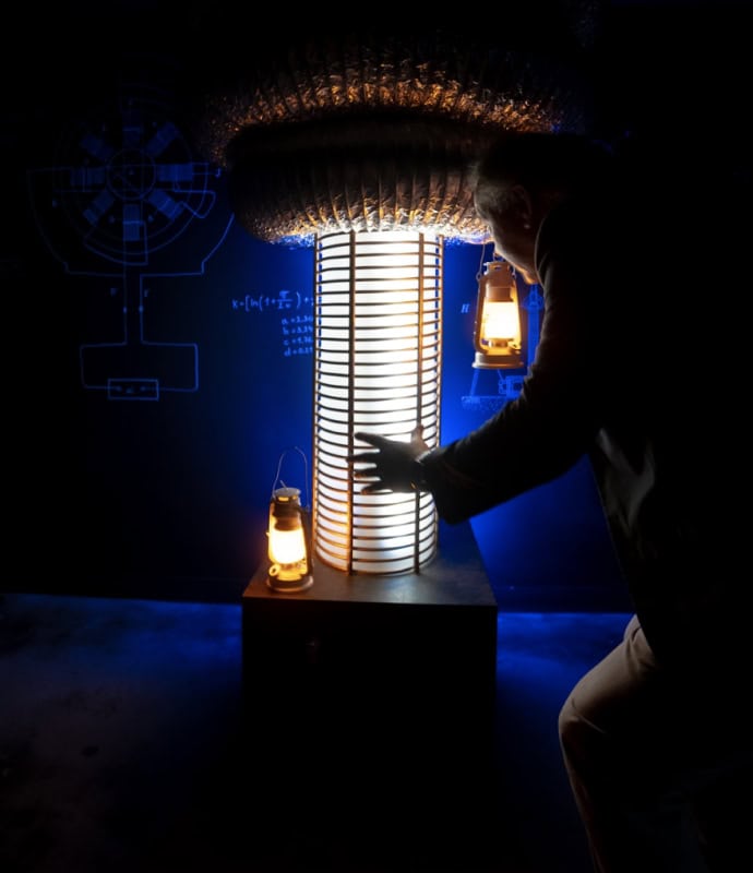 A person interacting with a futuristic escape room puzzle in Miami, illuminated by lanterns and blue.
