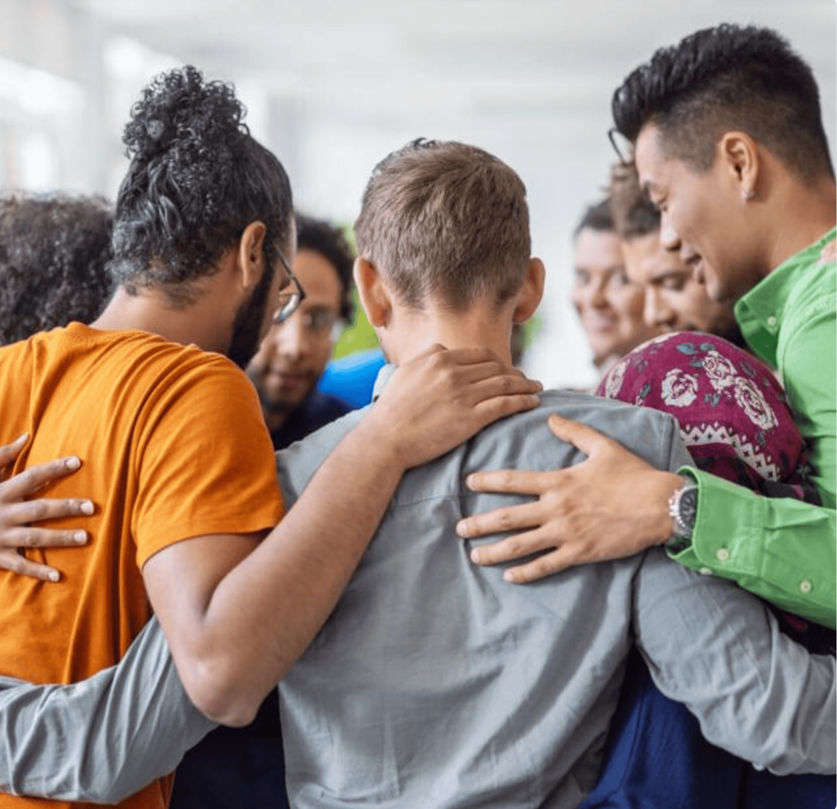 A group of diverse people huddled together in a team-building activity at Escape Room Miami.