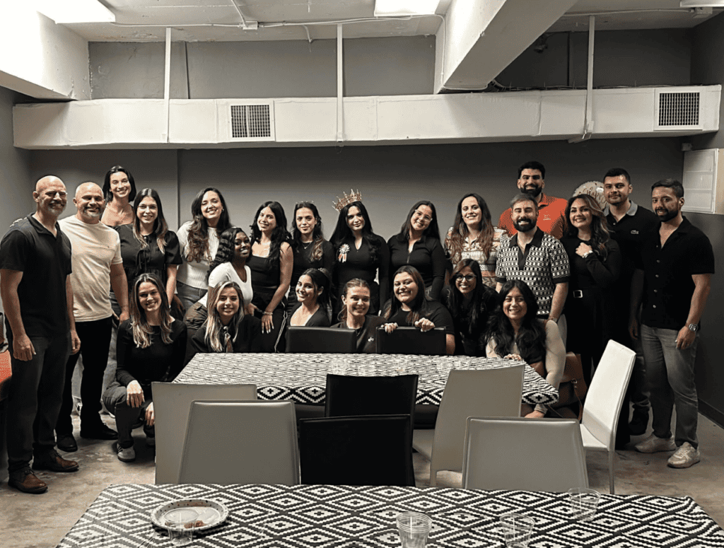 Escape room team celebrating at Fox in a Box Miami, group photo with players and staff.