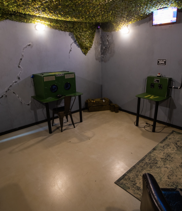 Escape room Stockholm with military-themed puzzle stations and weapon crates for immersive gameplay.