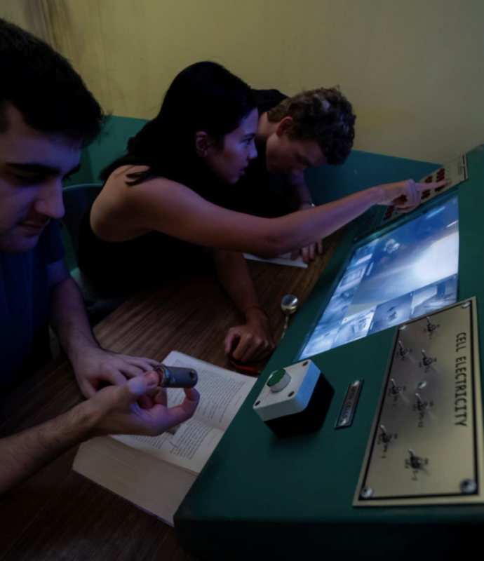 Board game escape room, team solving puzzles at Fox in a Box Stockholm.