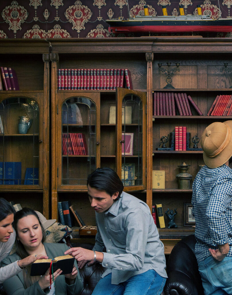 Shelves full of vintage books and artifacts at Fox in a Box Stockholm escape room.