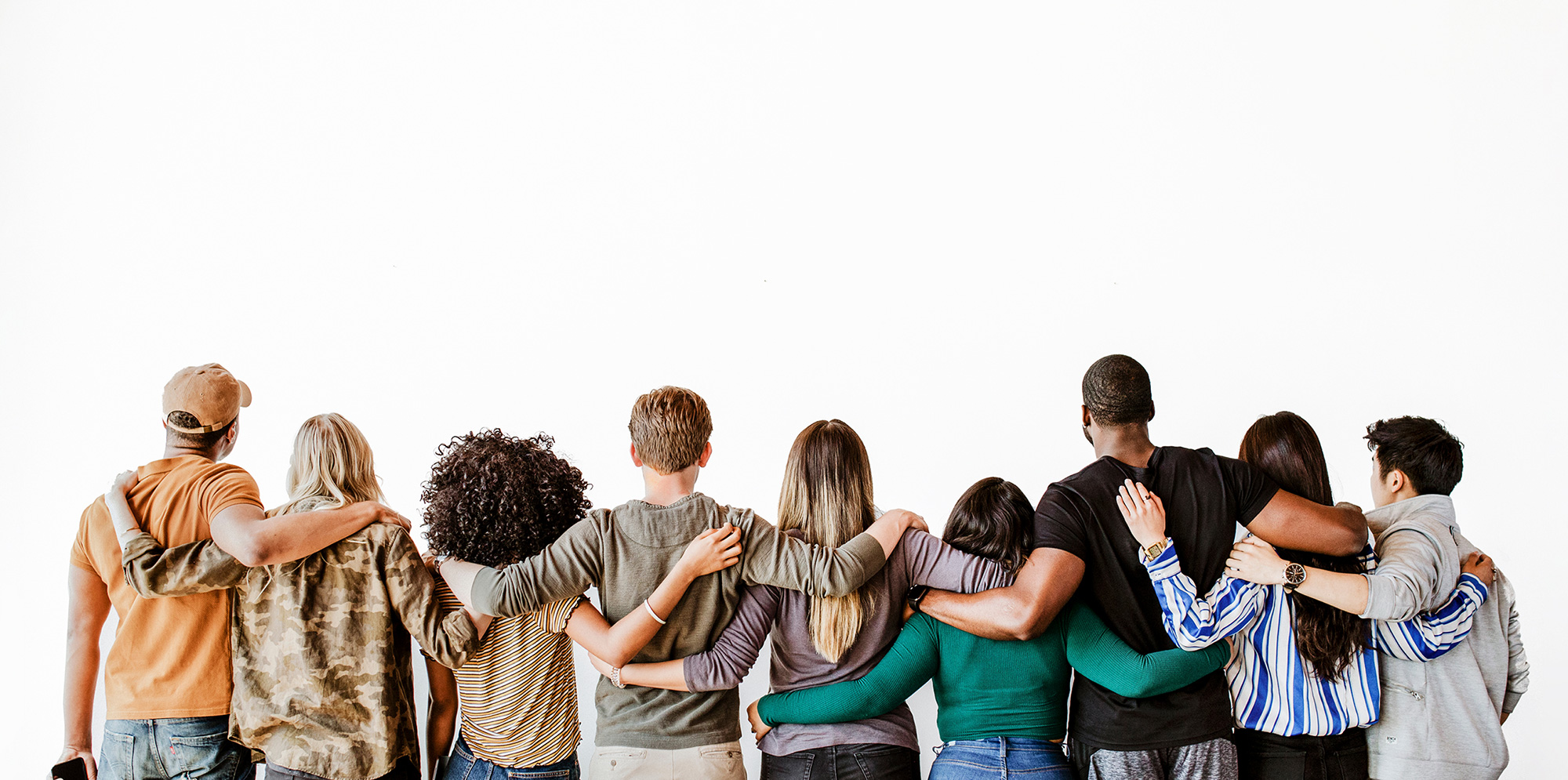 Group of diverse people embracing each other, enjoying team-building at Roomescape by Fox in a Box Stockholm.