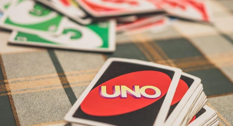 UNO game cards laid out on a checkered tablecloth at Roomescape by Fox in a Box Stockholm.