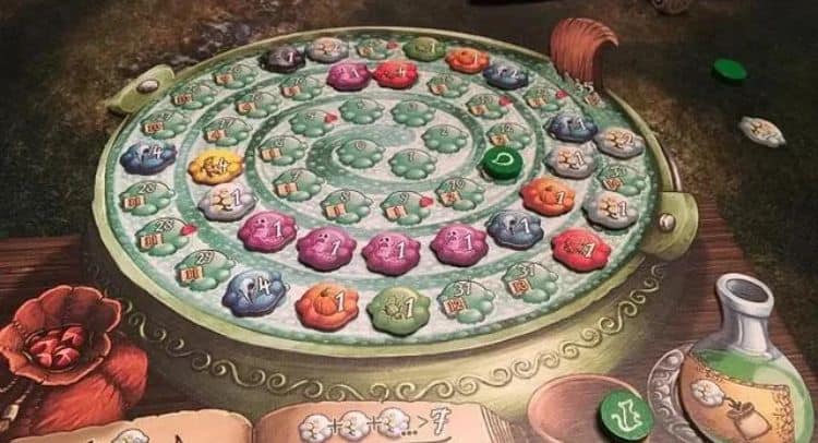 Colorful outdoor board game with animated pieces and decorative elements in a natural setting.